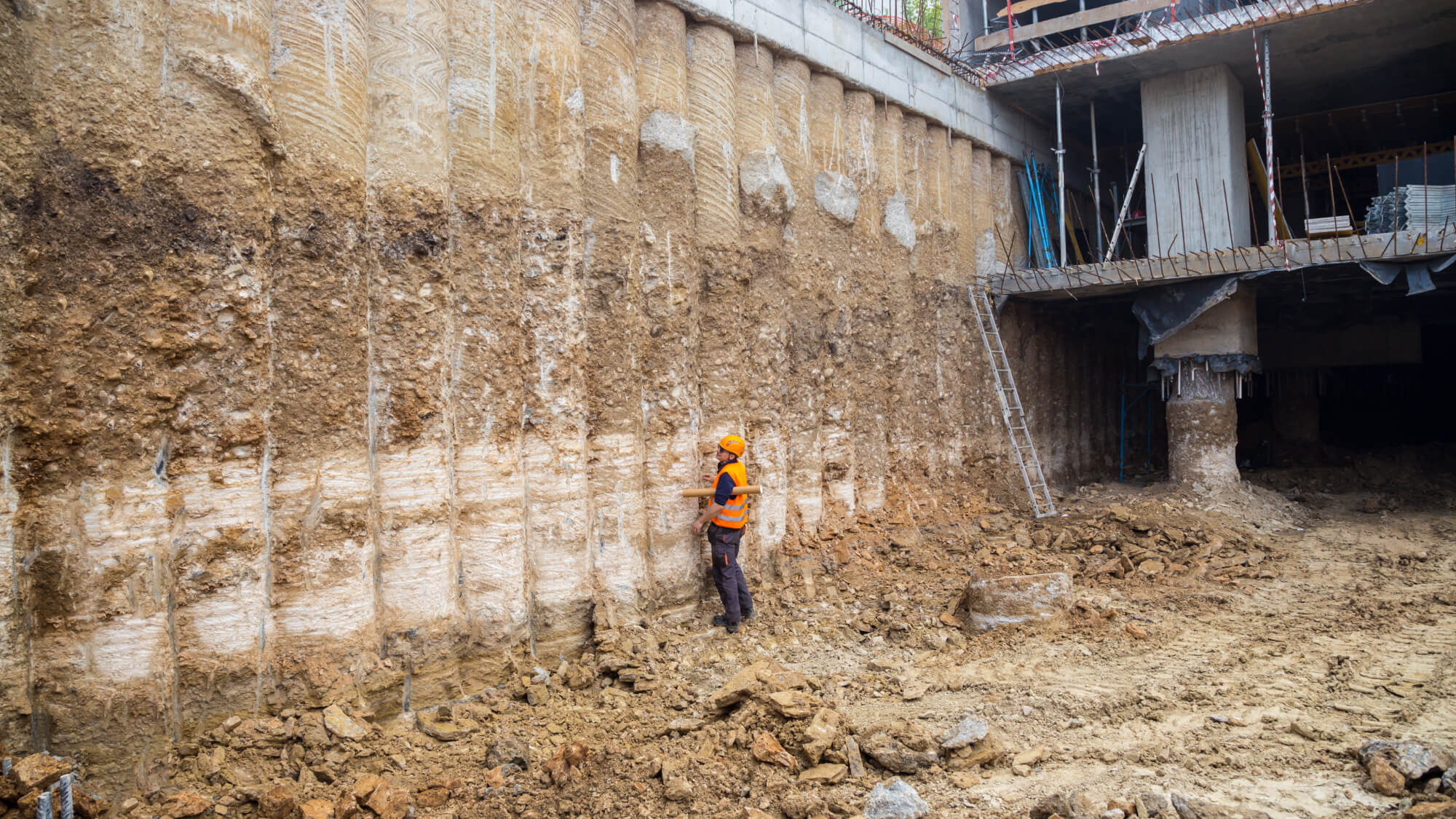  Construction worker checking pile retaining wall 
