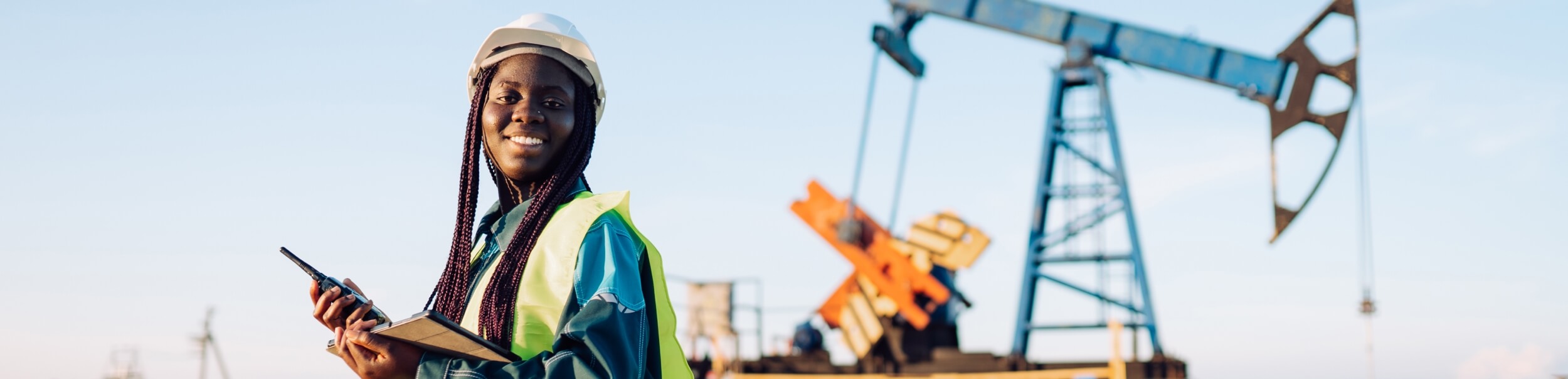 Oil drilling platform control buy female engineer with walkie-talkie and digital tablet