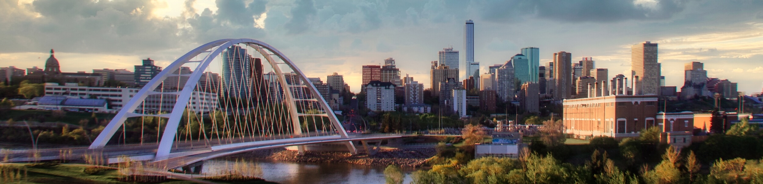 View of bridge over river against cloudy sky,Edmonton,Alberta,Canada