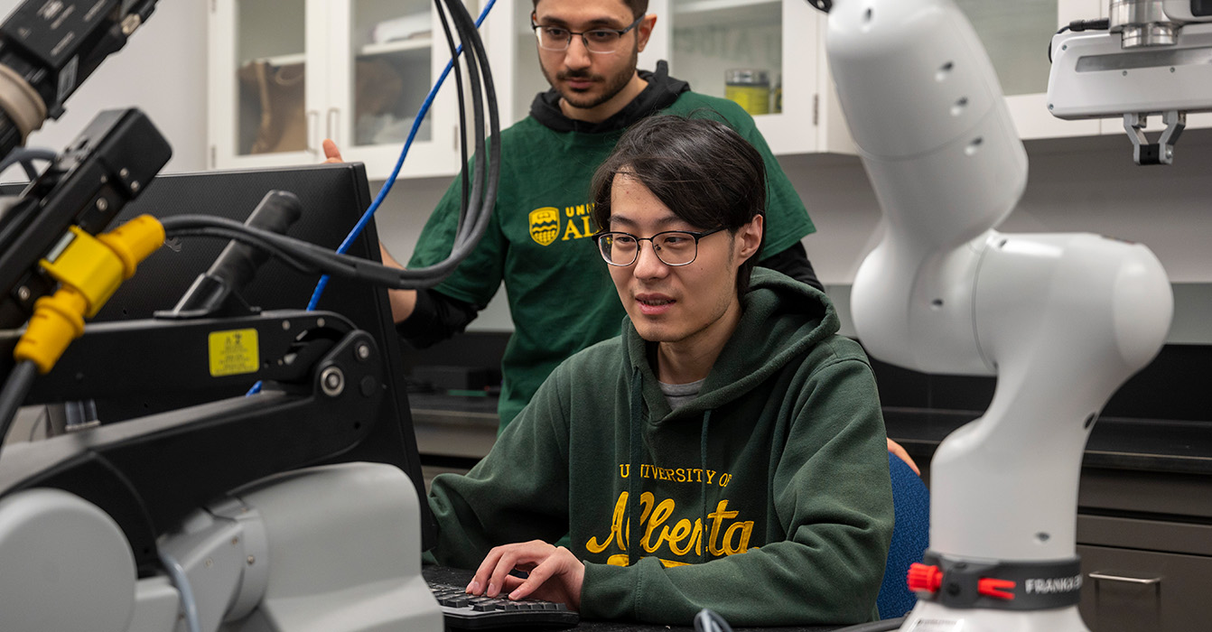 Two individuals complete research in the Tavakoli lab.