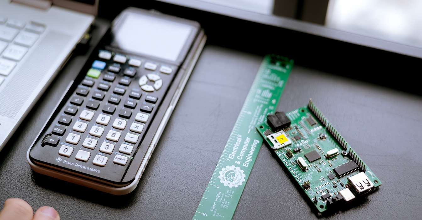 MINT materials including a calculator and laptop with a logic board.