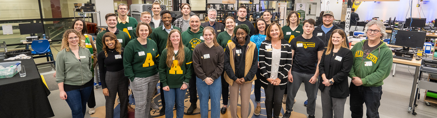 Engineering members pose for a group photo in a lab.