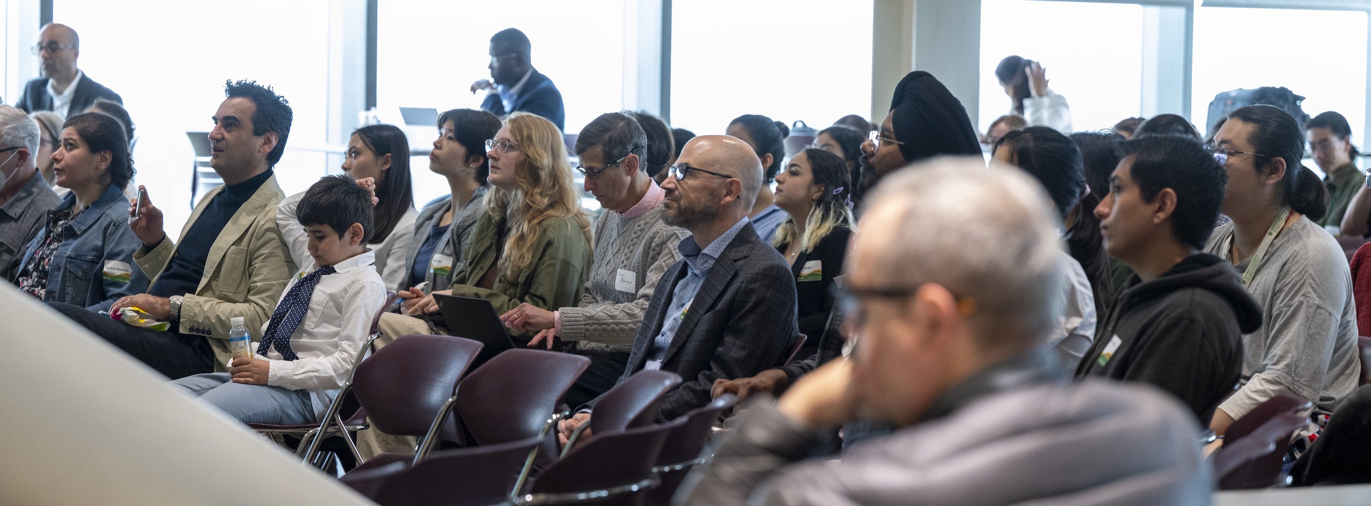 Audience seated and watching a speaker at Research Day 2024
