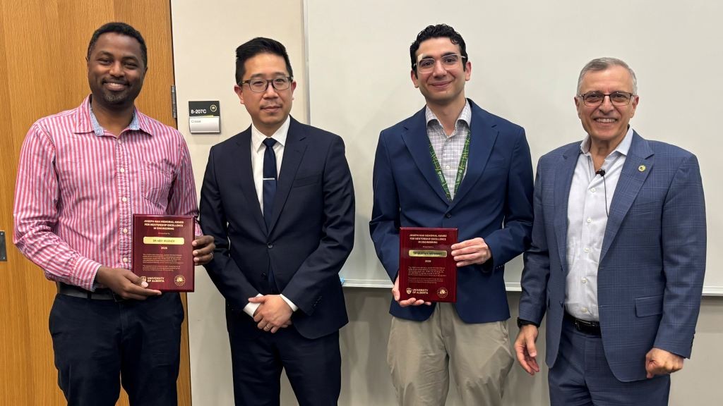 Andrew Mah holding award with winners