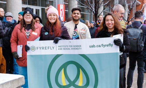 A group of students holding up a Fyrefly banner