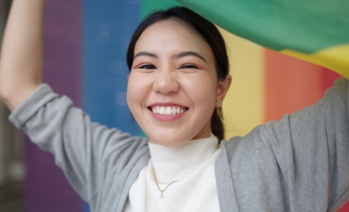 Smiling woman holding the pride flag