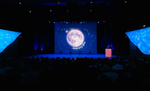 A presentation in a dark auditorium