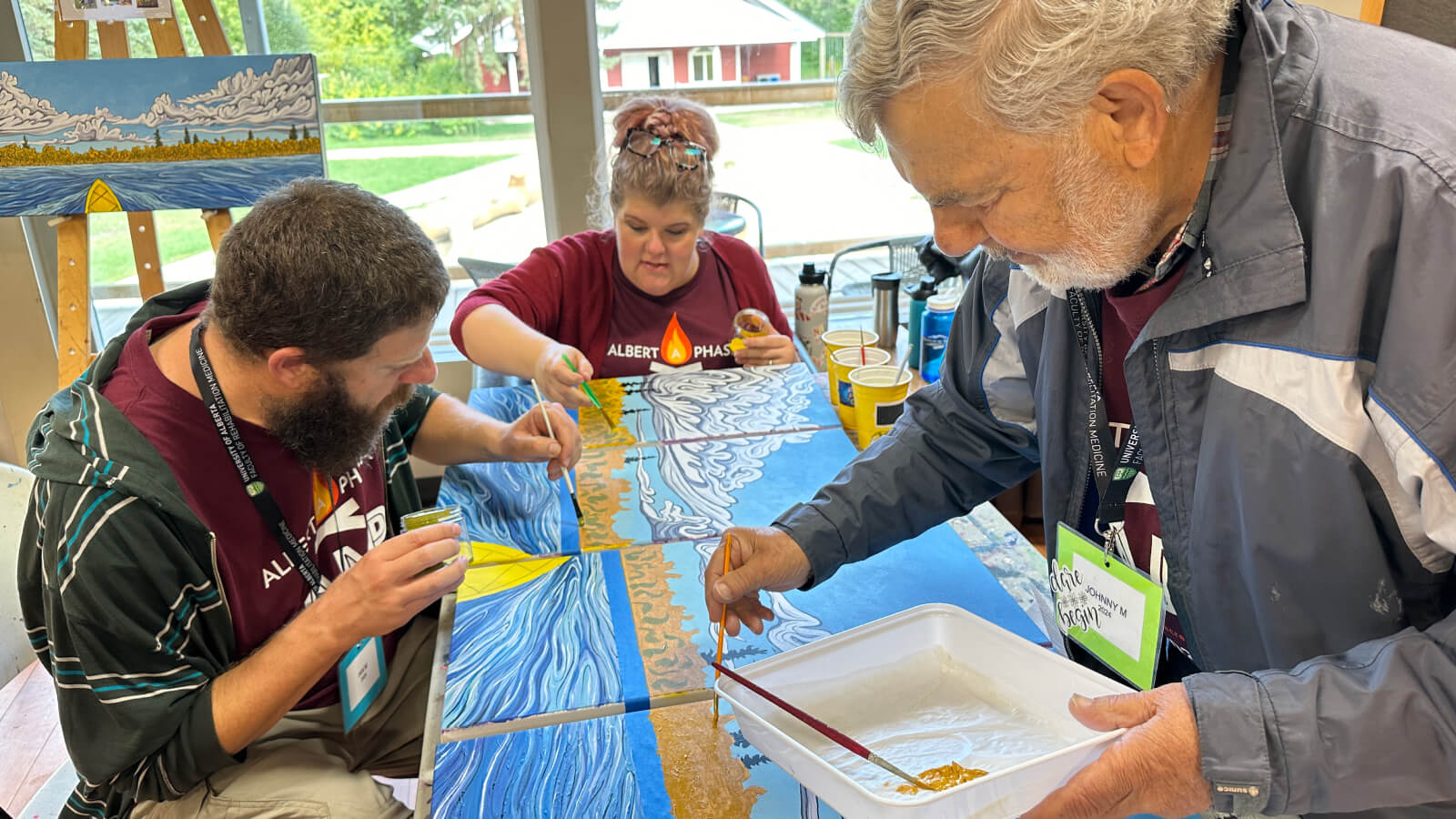 The inclusive nature of Megan Parker's art project during the 2024 Alberta Aphasia Camp was a highlight for Tiffany Badiuk and Ian Martens, who joined their father, Johnny Martens, at camp, as it allowed every camper to feel their contributions were valuable.