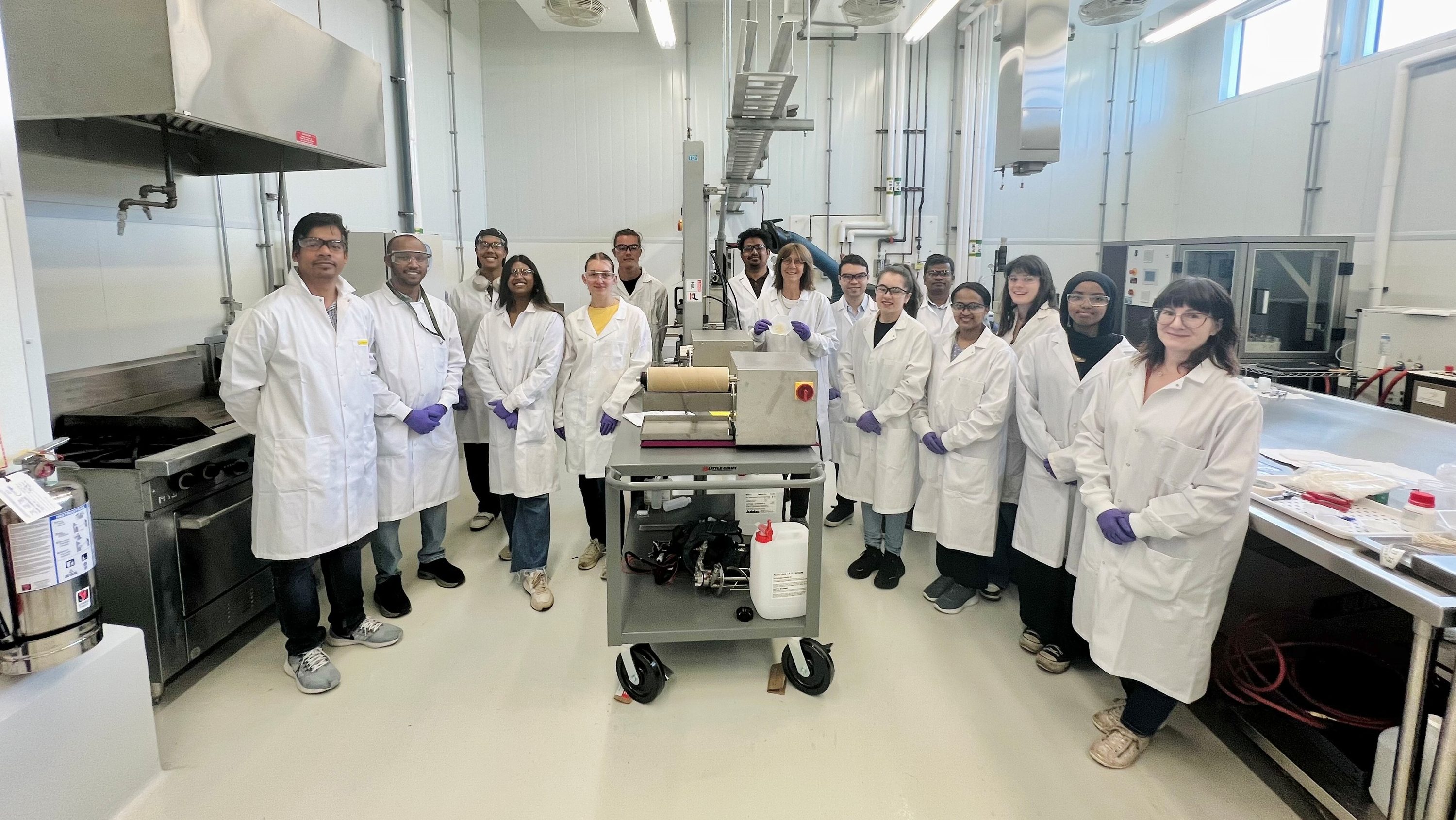 A U of A research team led by Patricia Dolez (centre, holding fibre sample) and Lelia Lawson (end right) is now manufacturing metres of specialized fibres from cellulose in Canadian-grown hemp. (Photo: Supplied)
