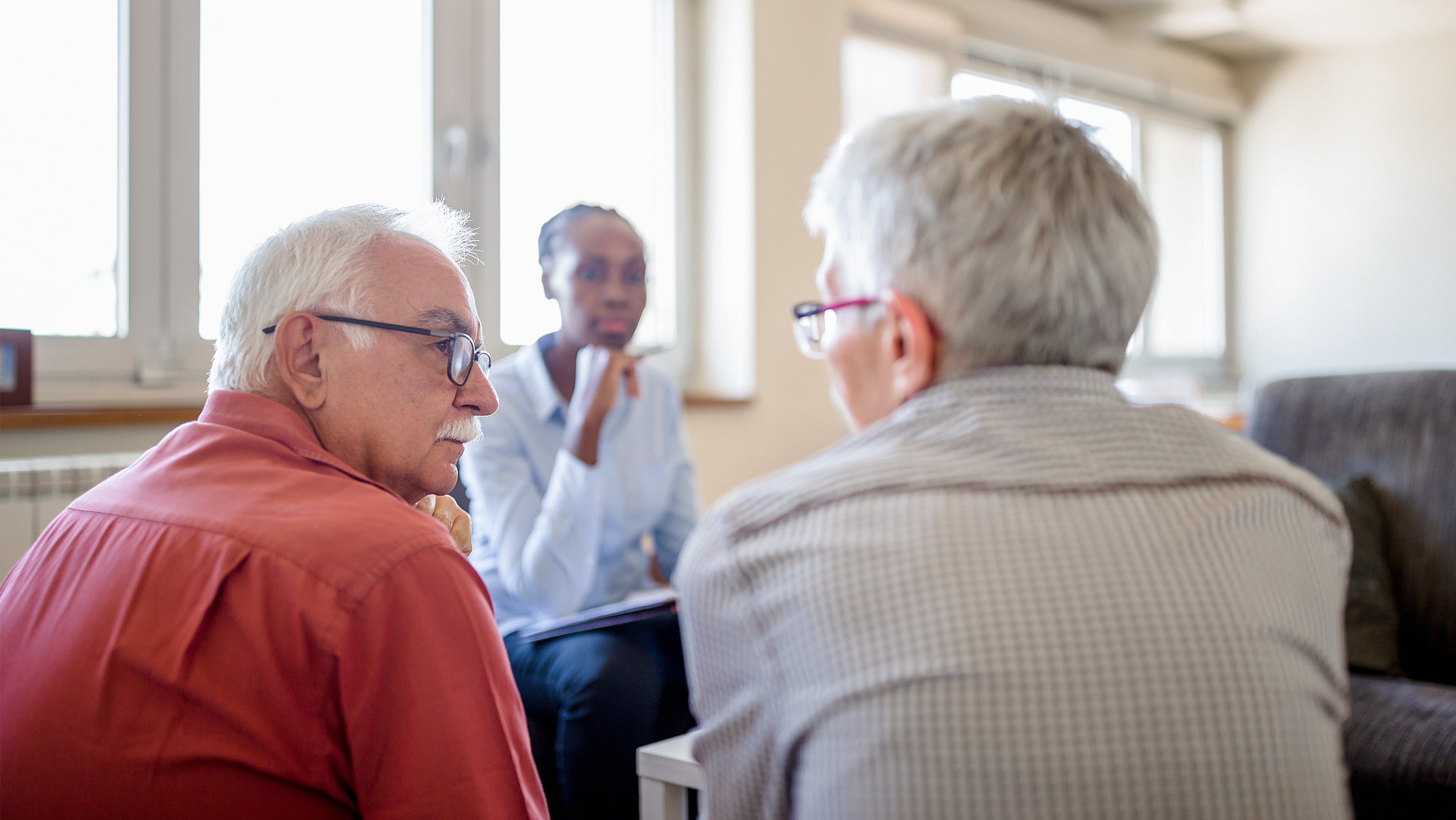 A senior couple sits together in a therapy session. (Photo: Getty Images)
