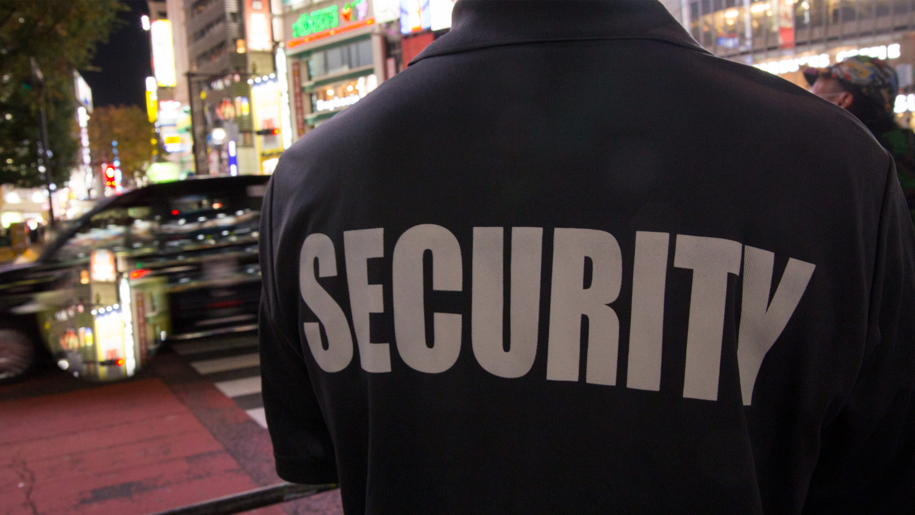 A security guard surveys a busy urban area. (Photo: Getty Images)