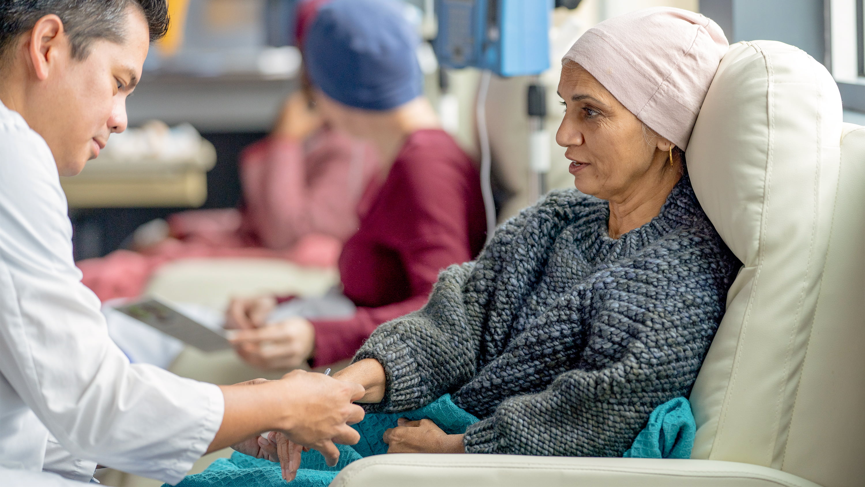 A woman with cancer is treated by a doctor
