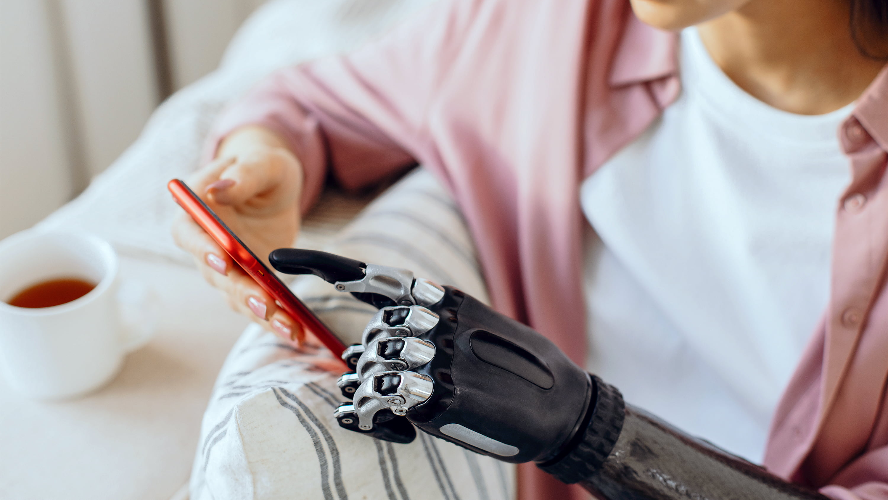 A robotic arm touches a smartphone