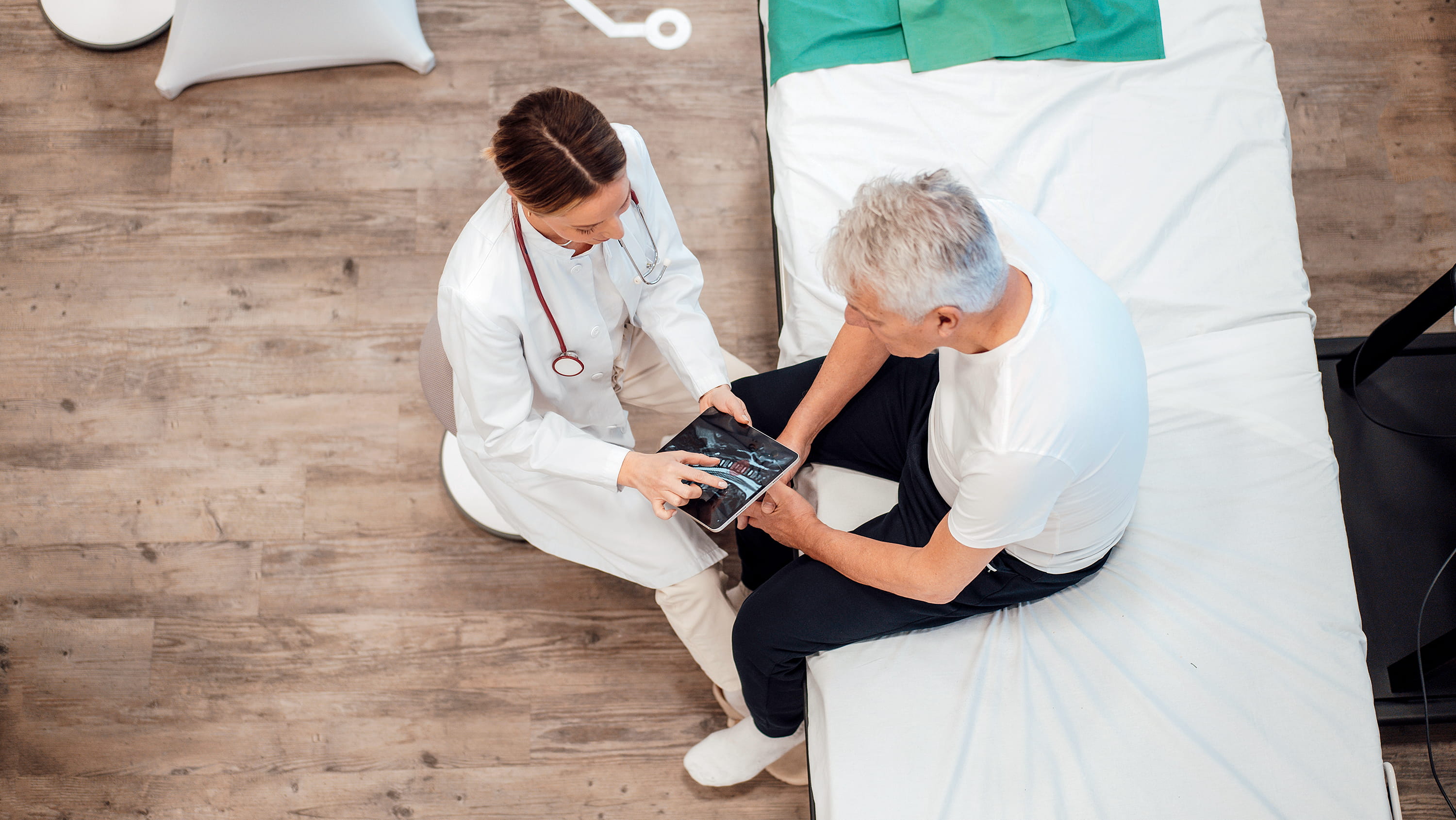 Doctor shows patient tablet via Getty Images