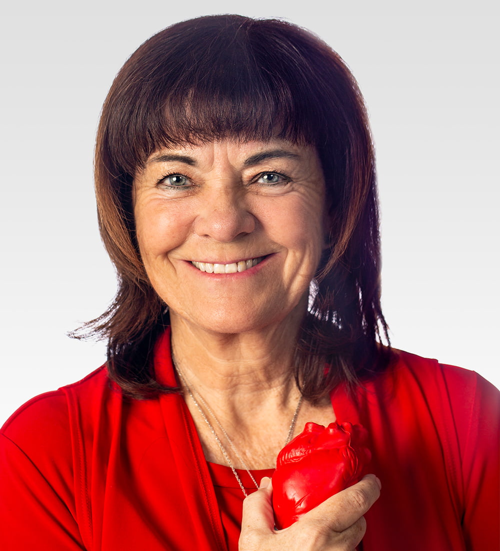 Nursing researcher Colleen Norris holds an anatomical model of a human heart.