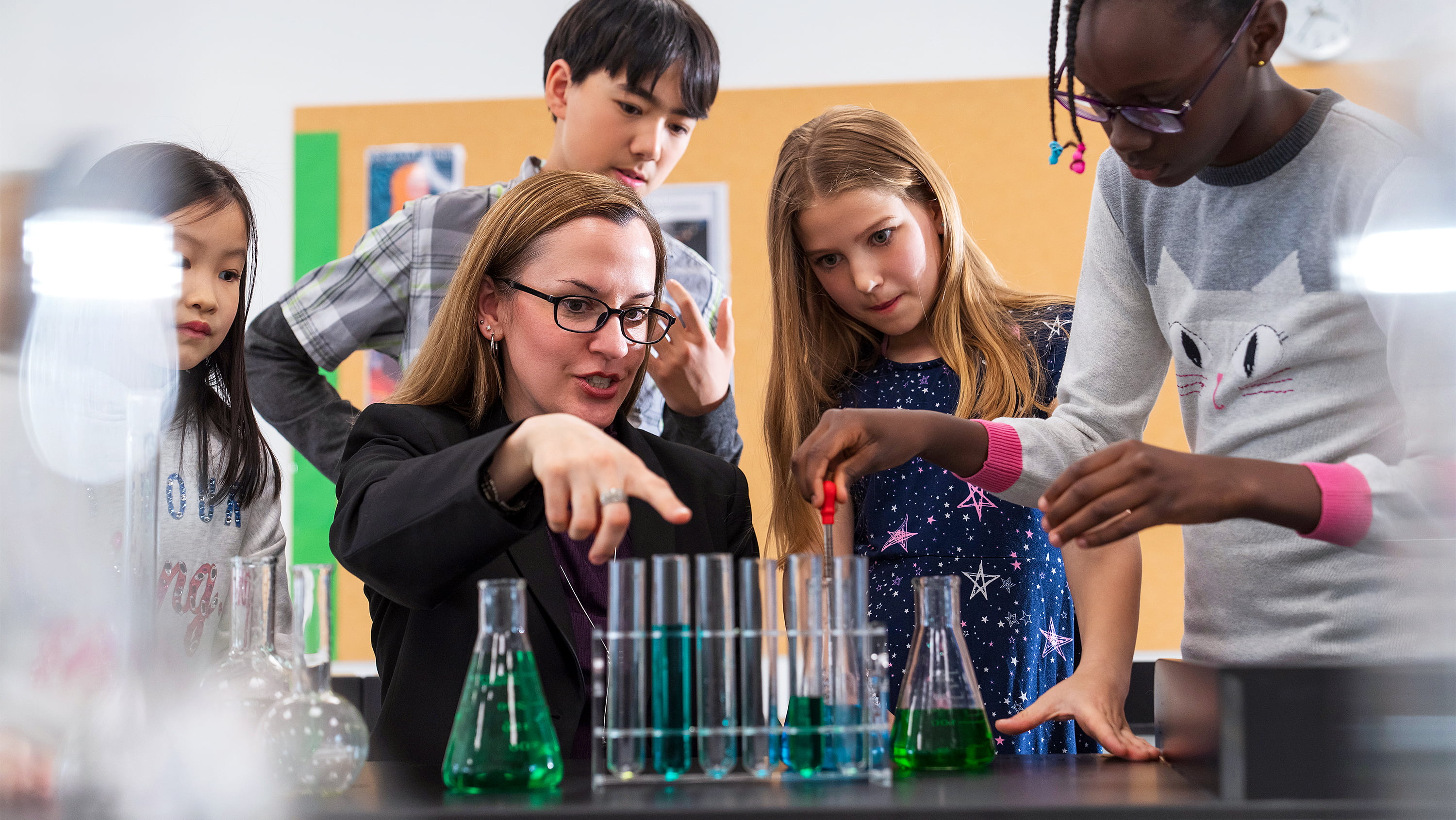 Kids look at beakers Getty 