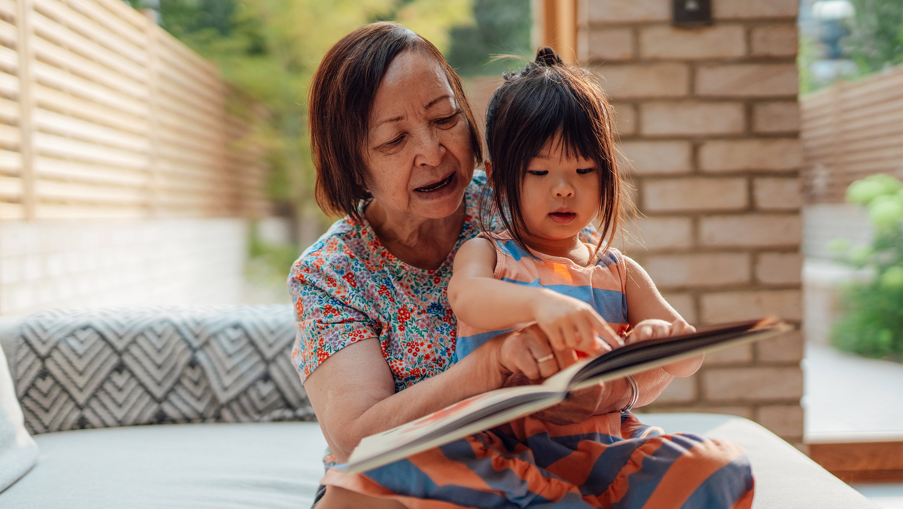 Grandmother reads with granddaughter 