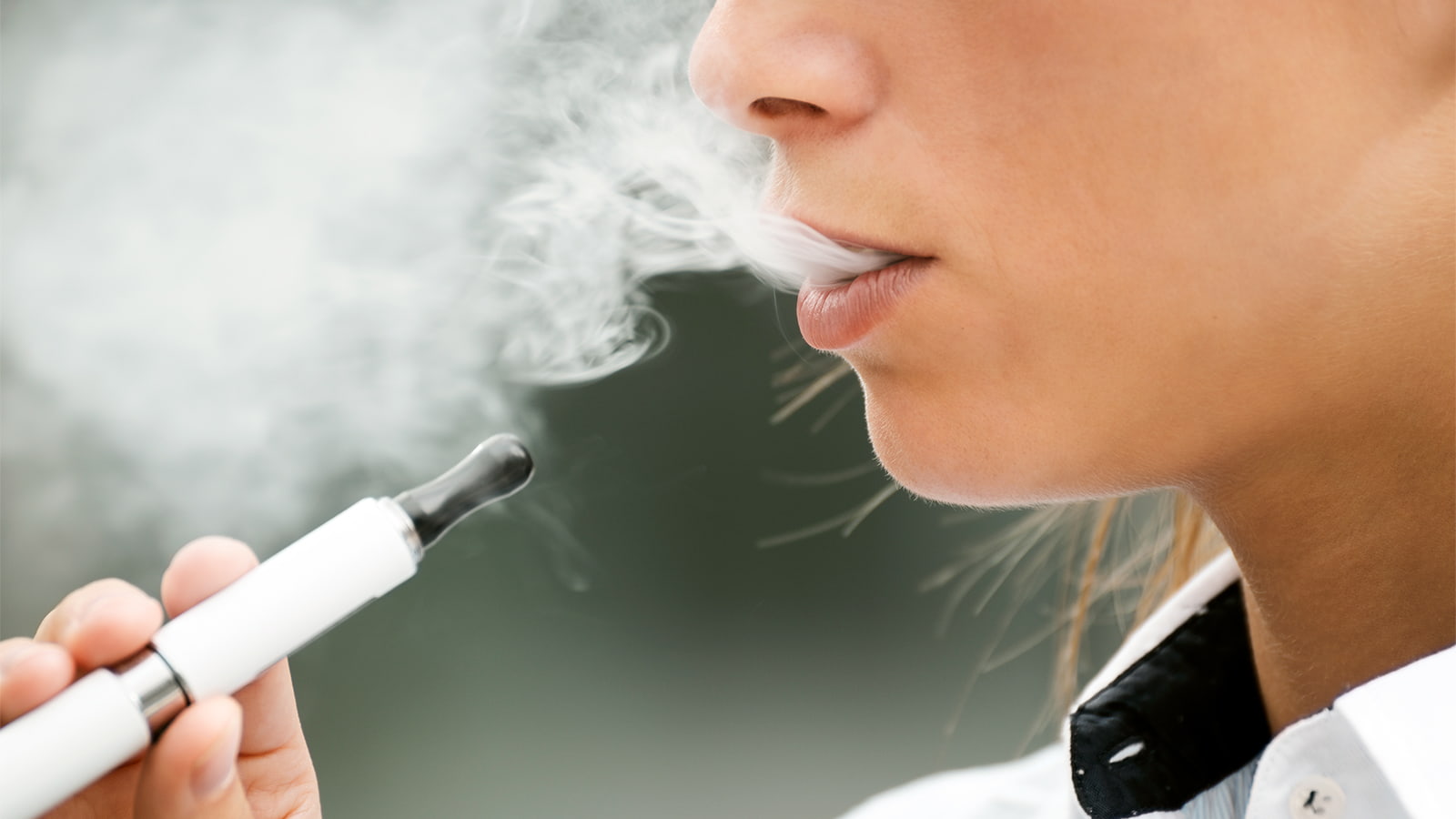 A young woman puffs on an electronic cigarette. (Photo: Getty Images)