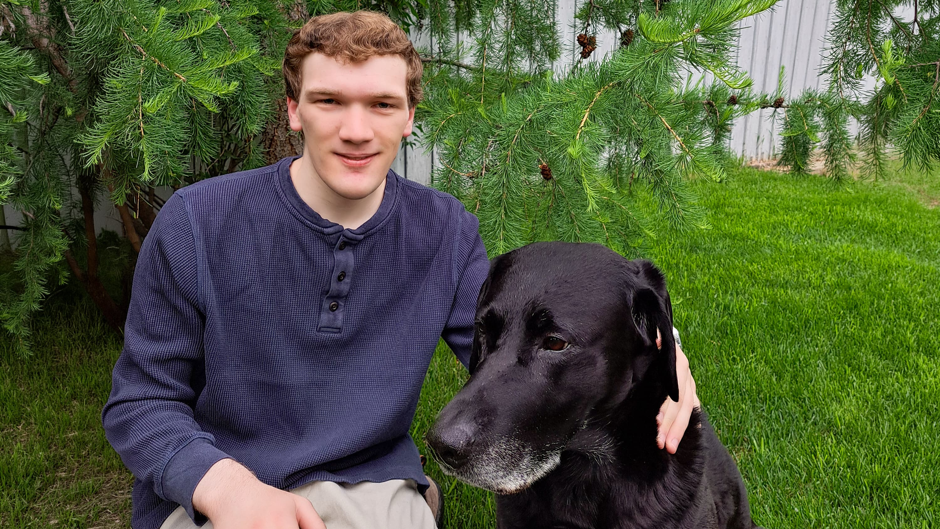 A photo of Christopher Moore beside his dog.