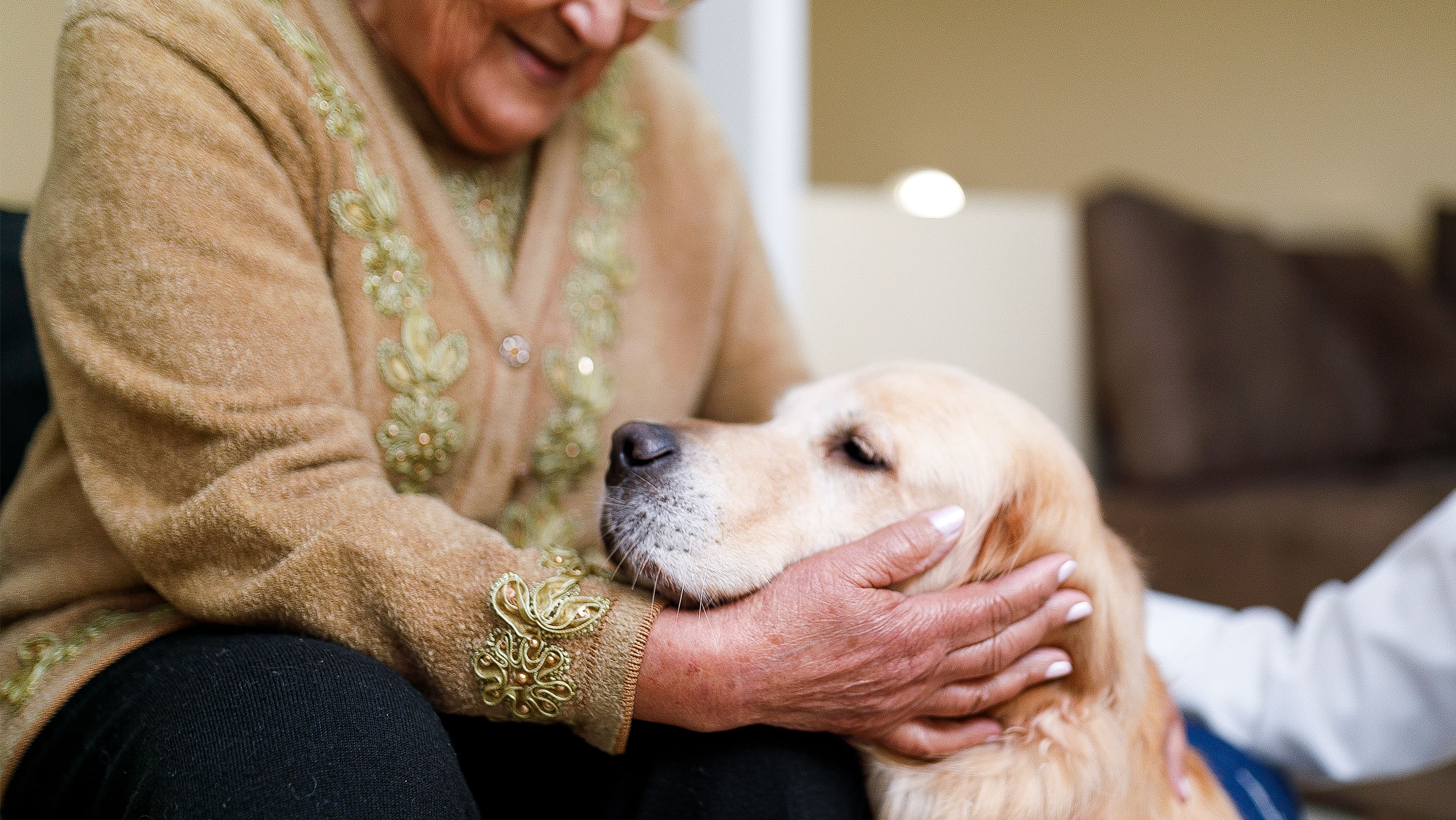 A senior woman cradles a dog's head. (Photo: Getty Images)