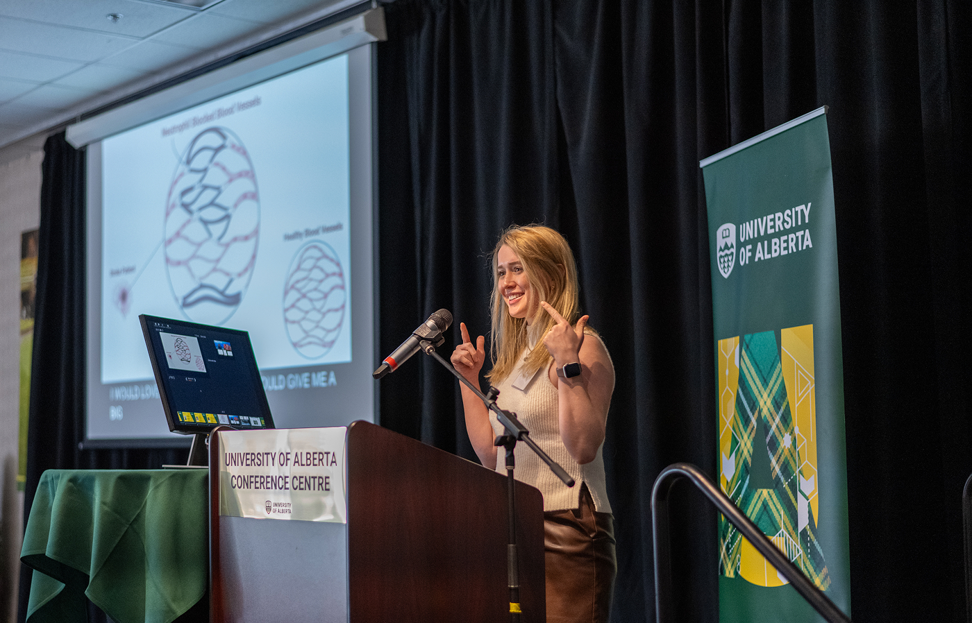 A speaker at a podium presenting a presentation