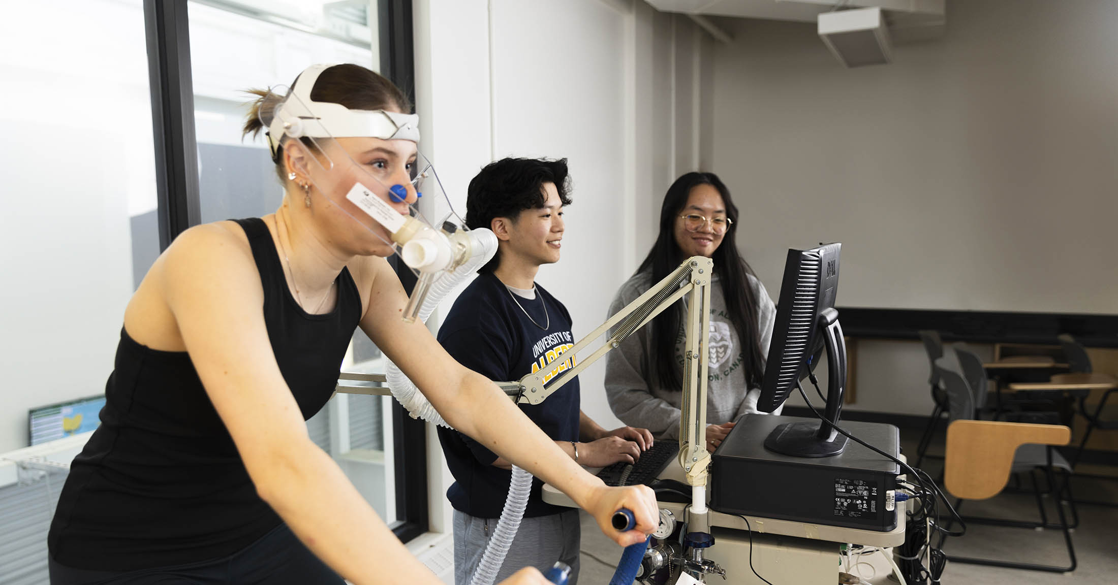 Woman on a stationary bike with breathing aparatus on