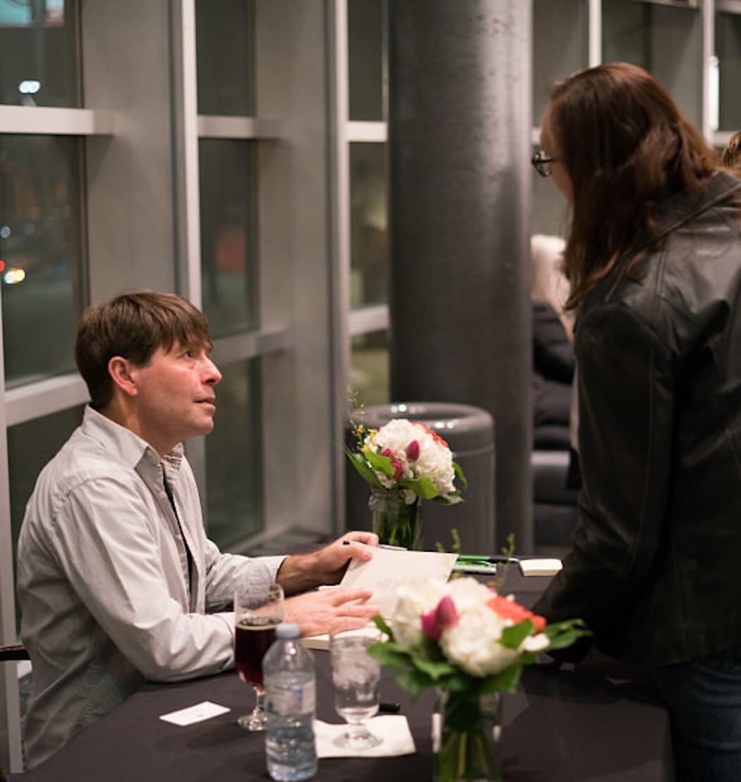 Photo of Michael Crummey Signing a Book at the 2018 Kreisel Lecture