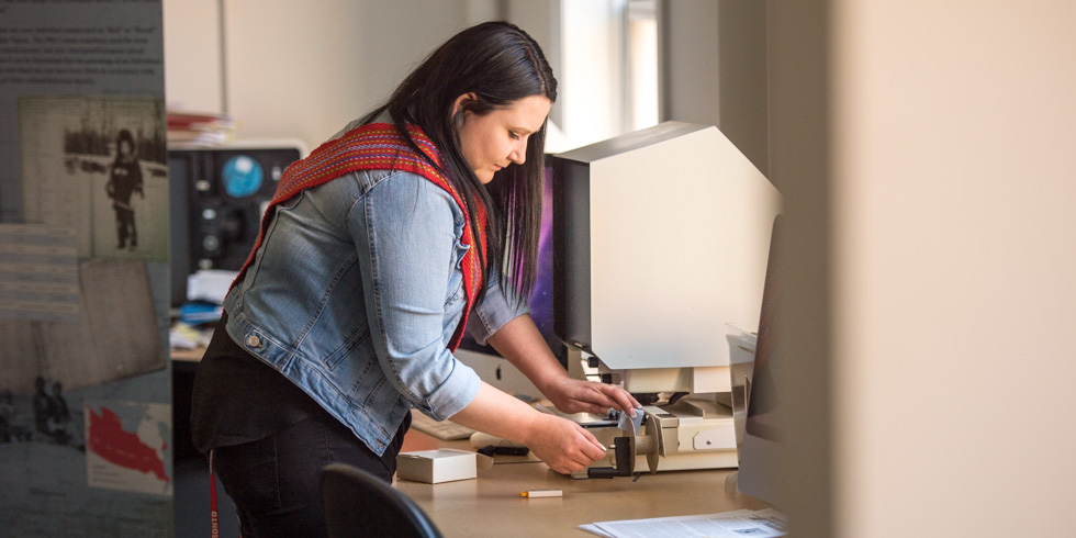 Kayla Lar-Son works with archival documents in the lab at the Faculty of Native Studies.