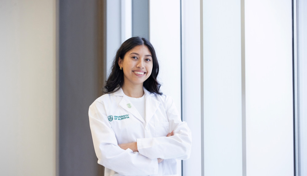 Medical student standing by a window