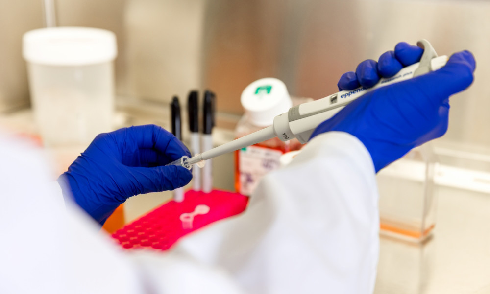 Lab worker filling a syringe