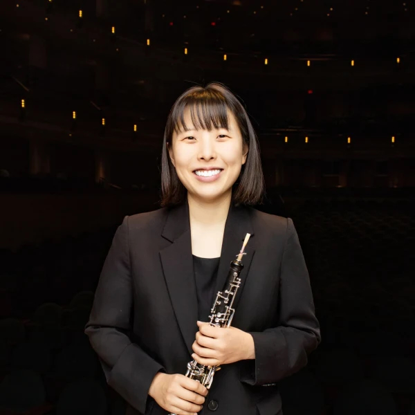 photo of June Kim holding an oboe