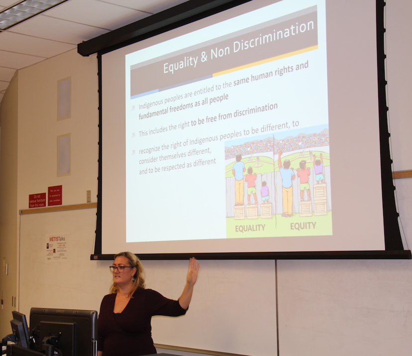 Brenda Gunn speaking in front of a projector displaying a slide on Equity vs Equality