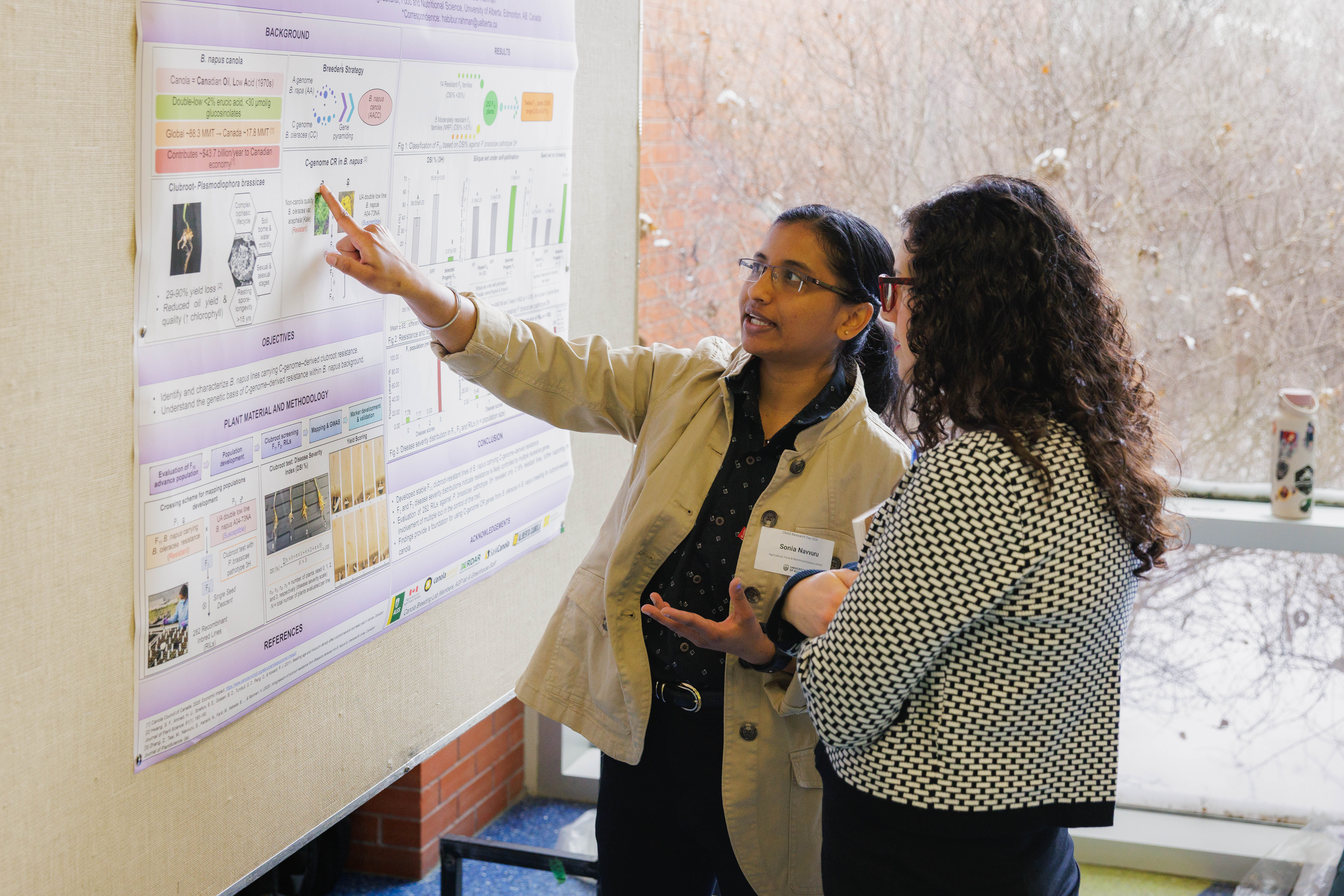 Student points to research poster