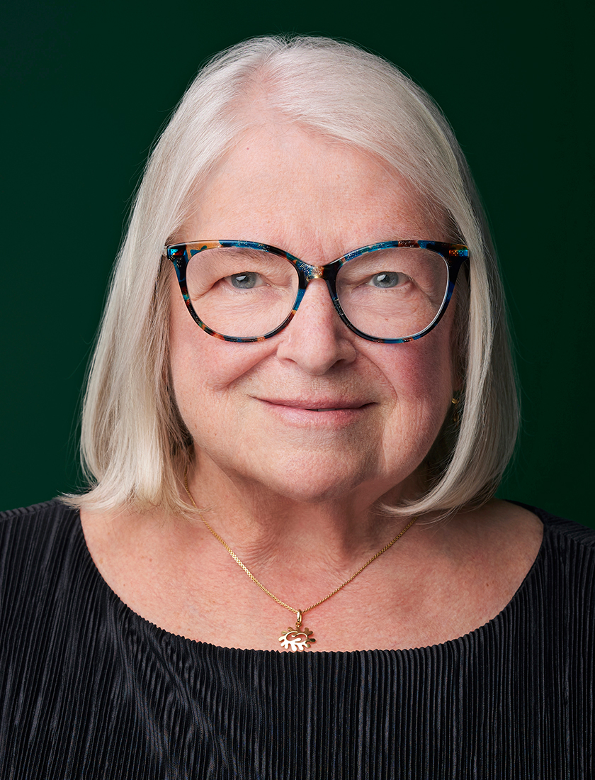 colour photo of Linda Ogilvie, dark green background
