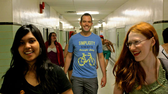 Teacher Tom Yonge walks down the hall with his students