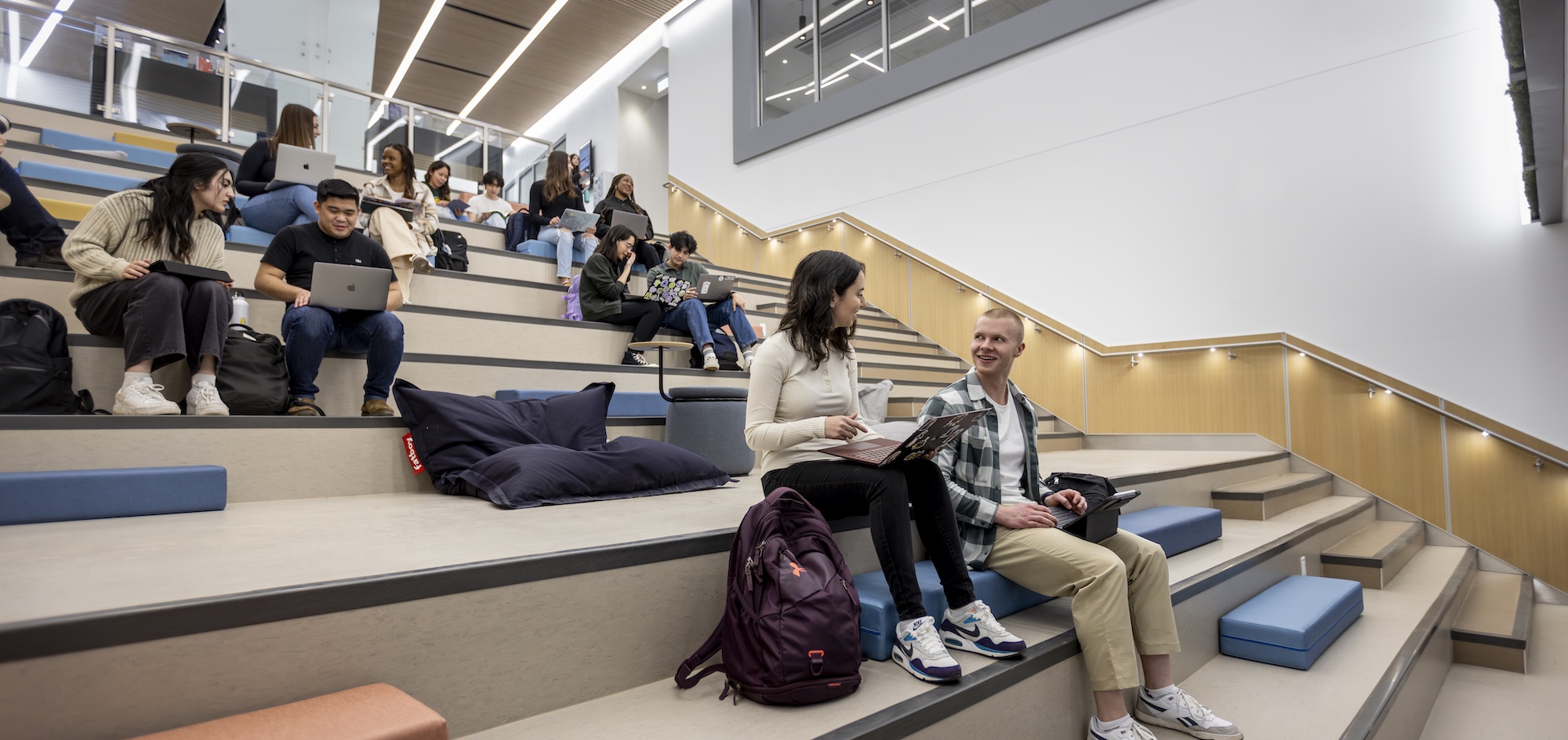 Students sitting and studying on lounge stairs
