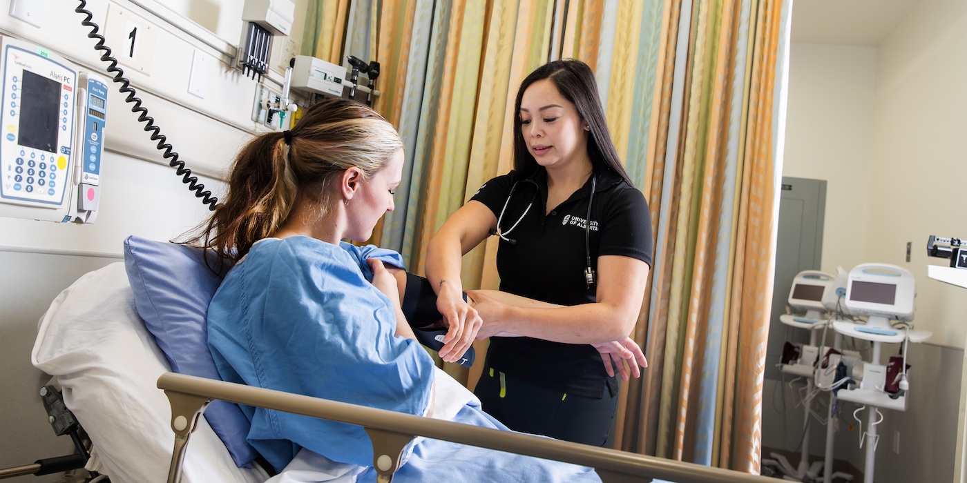 Nursing student working with a patient