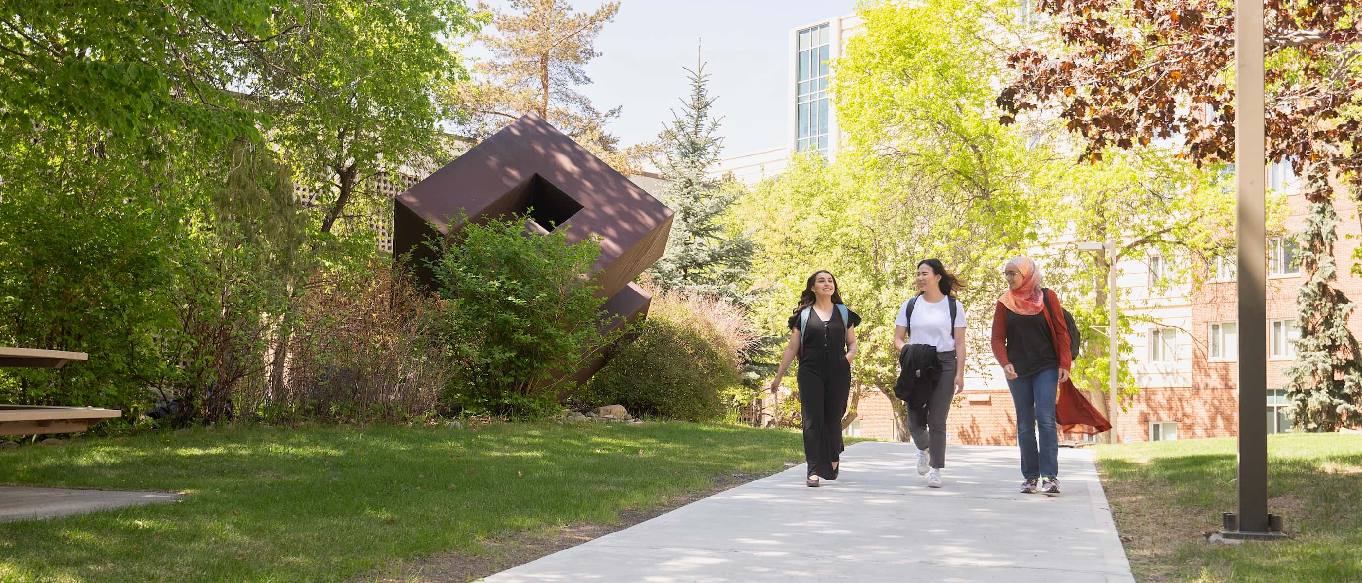 3 students walking on campus