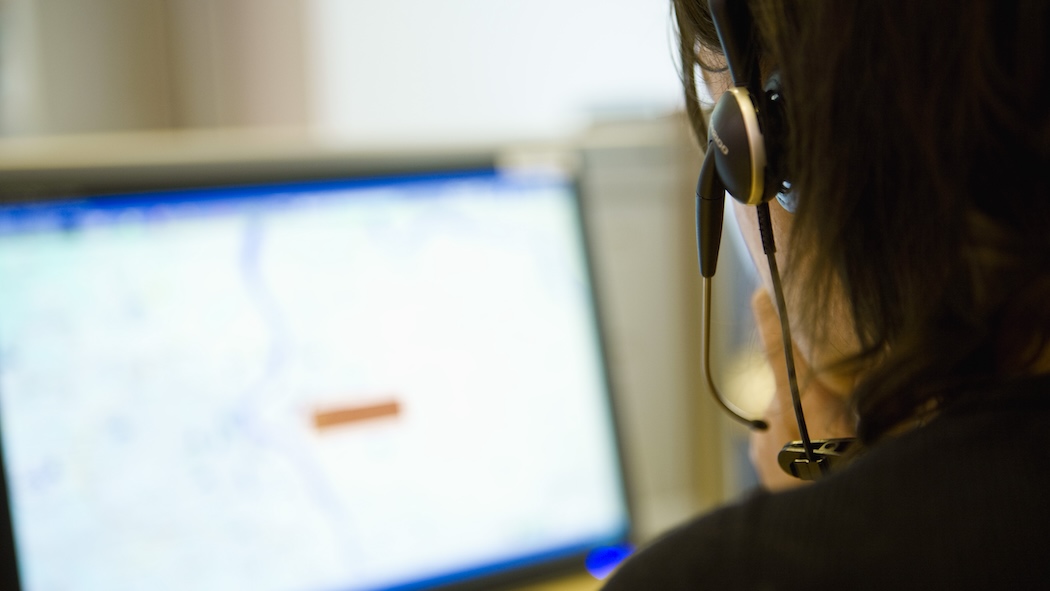 Stock image of a dispatcher and their computer