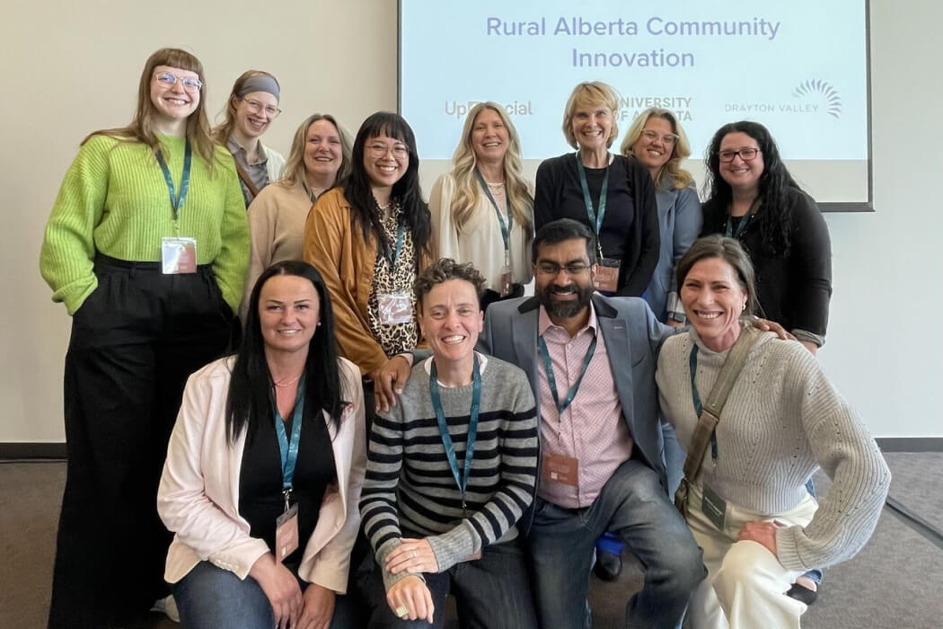 Group photo of 12 members of the Community-University Partnership team
