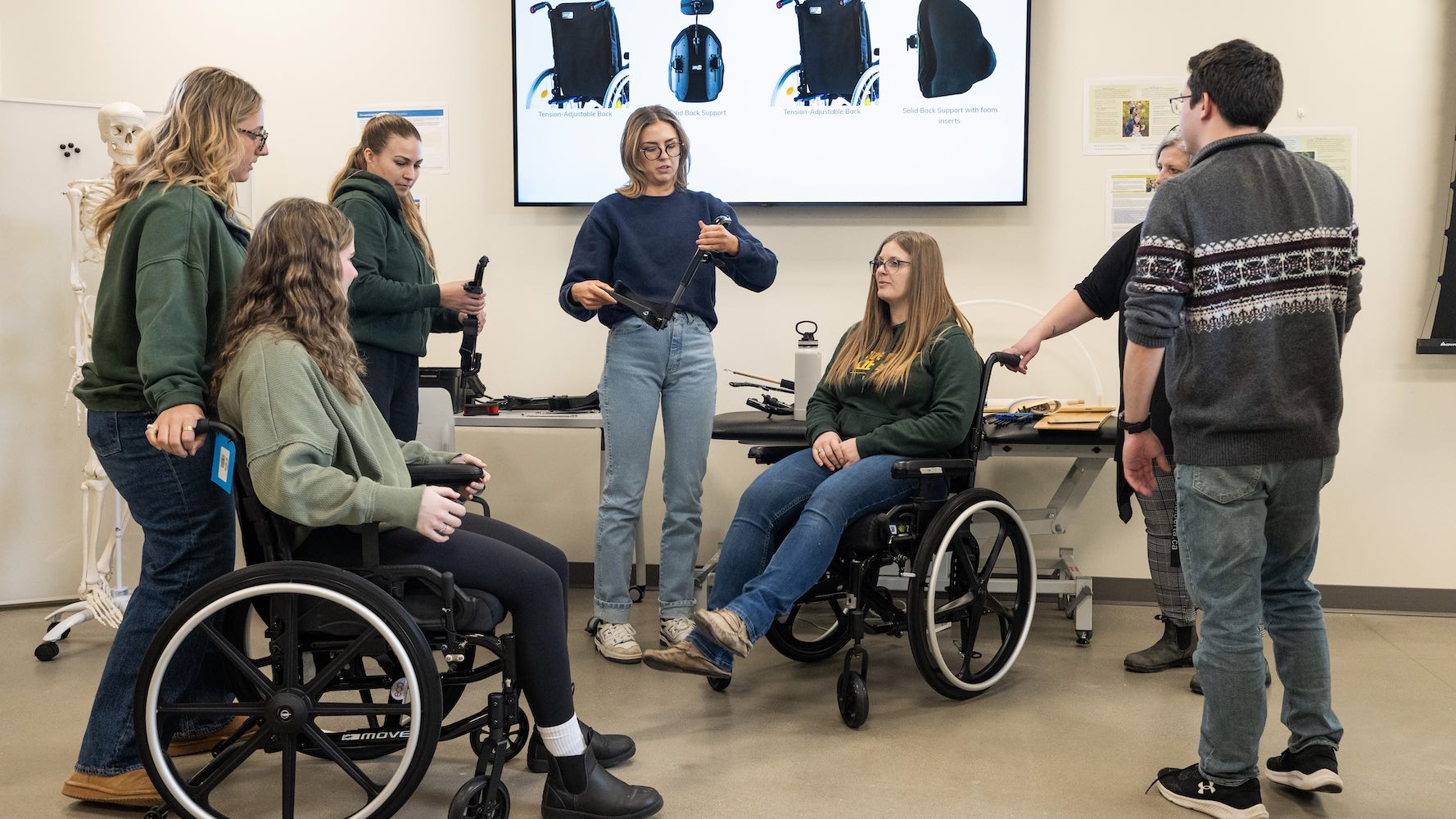 Rehab Med professor instructing a group of wheelchair users in mechanical motion