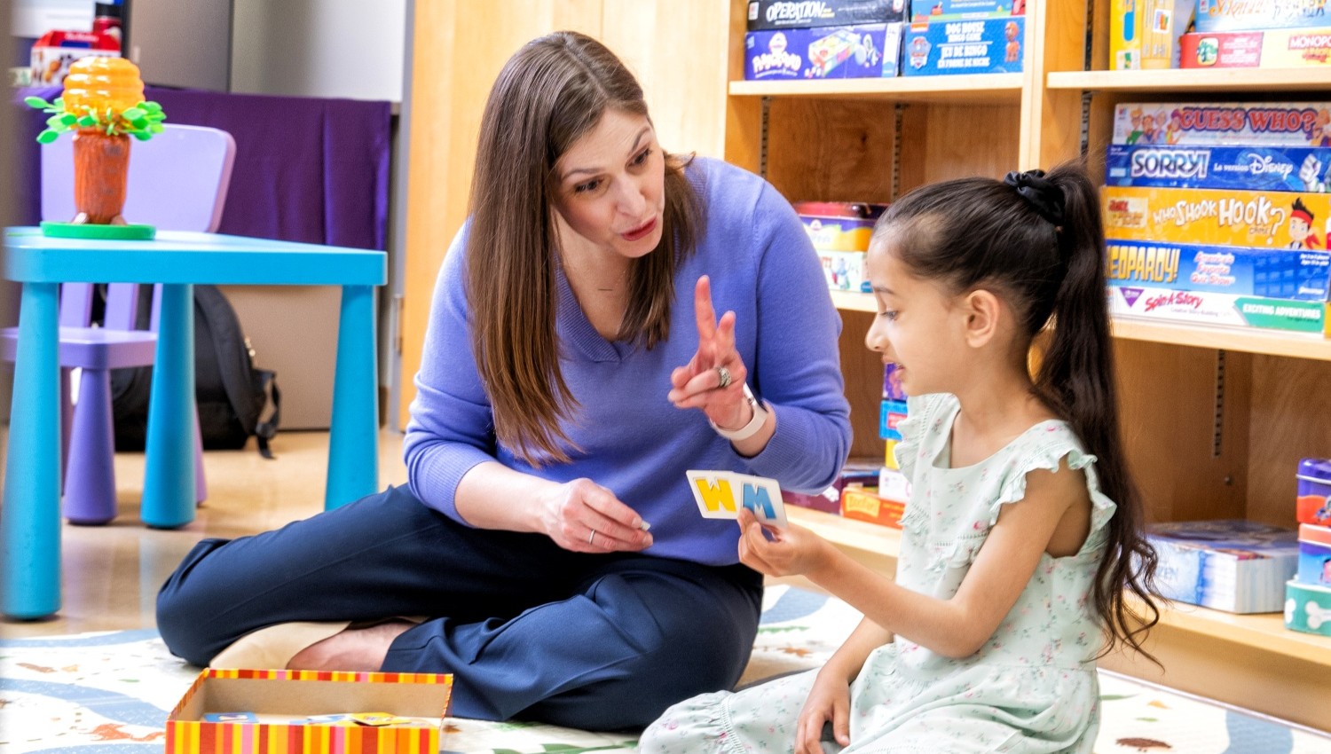 A speech language pathologist working with a small child