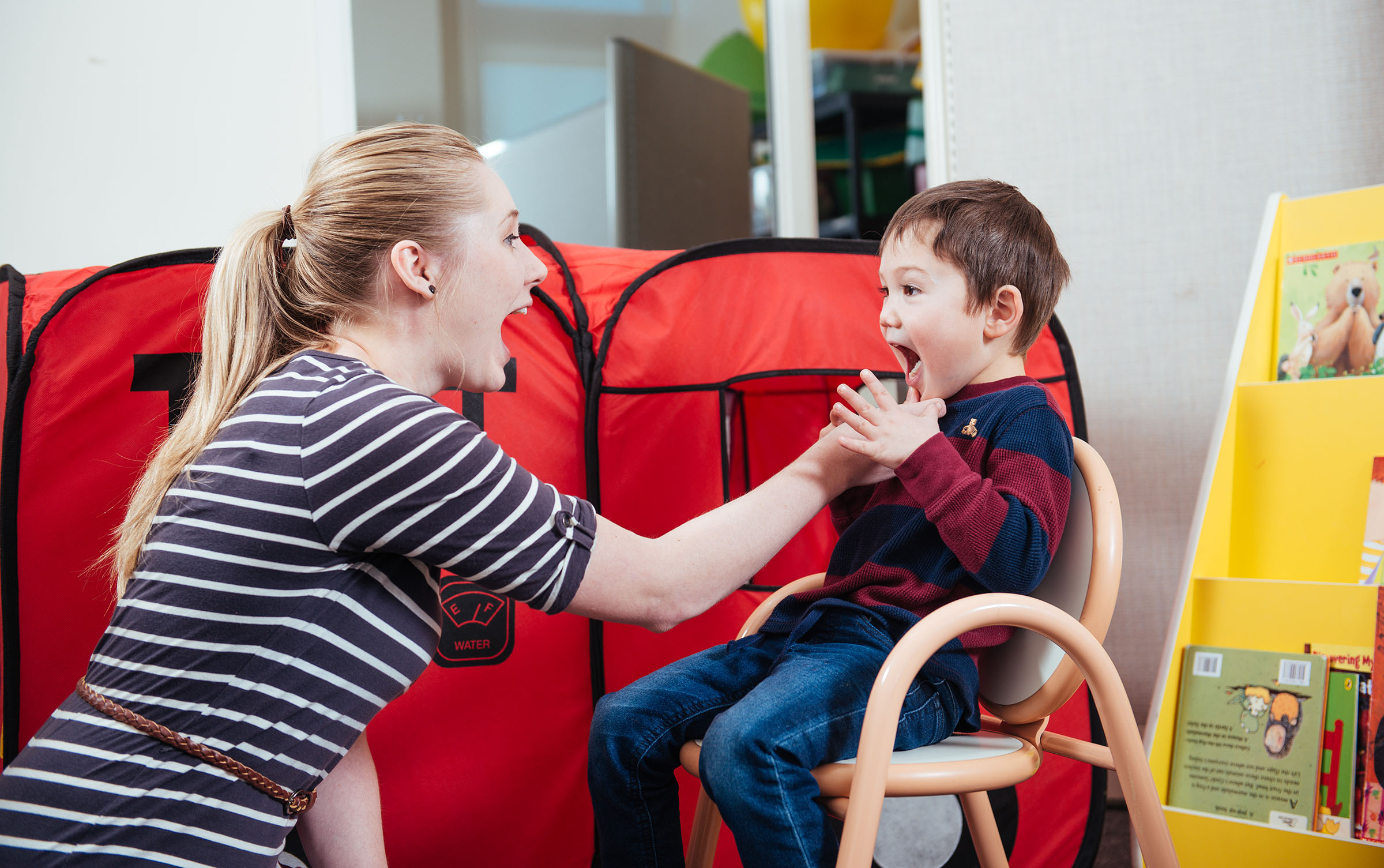 Woman helping a child talk