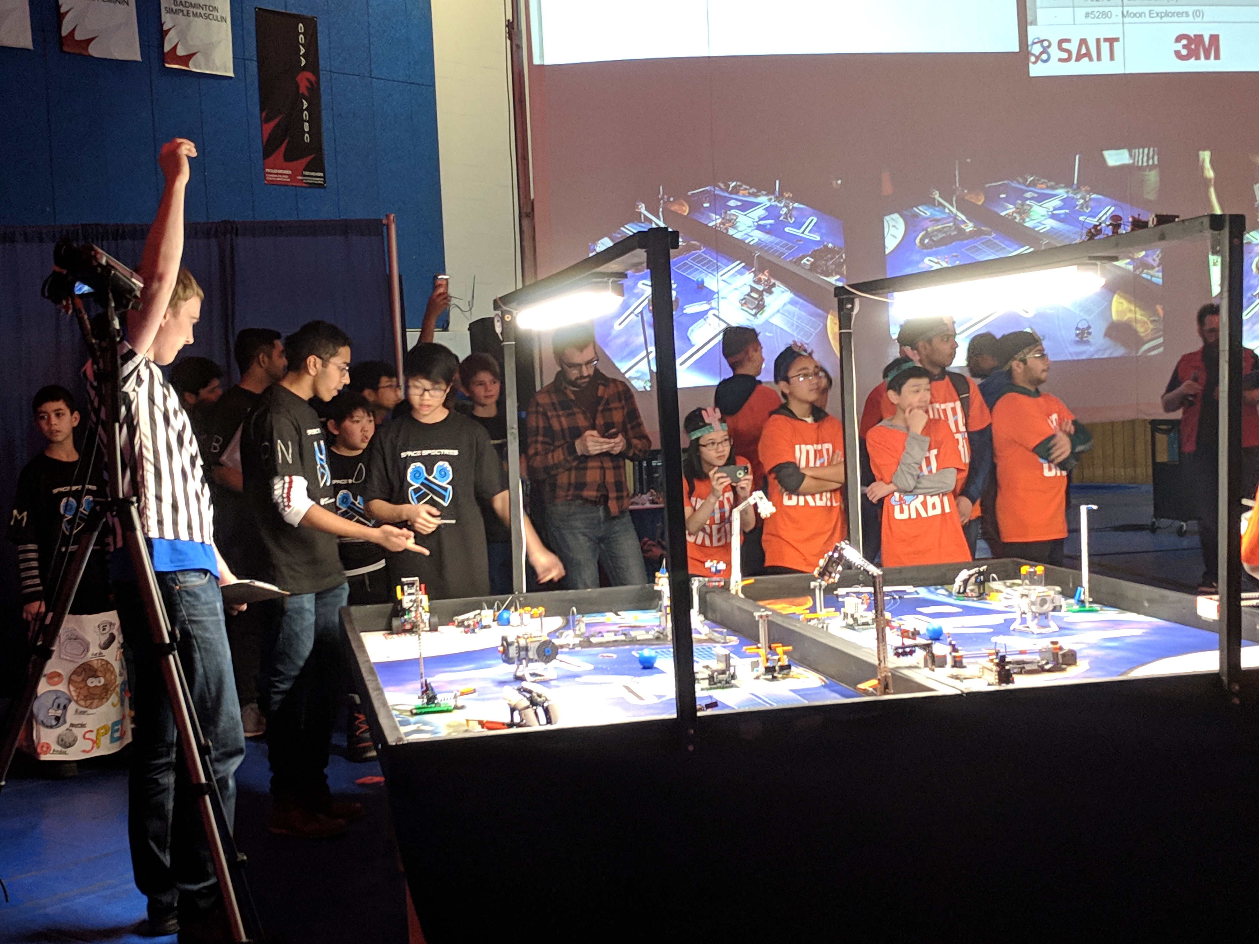 Children gathered around a table during a FIRST LEGO League competition