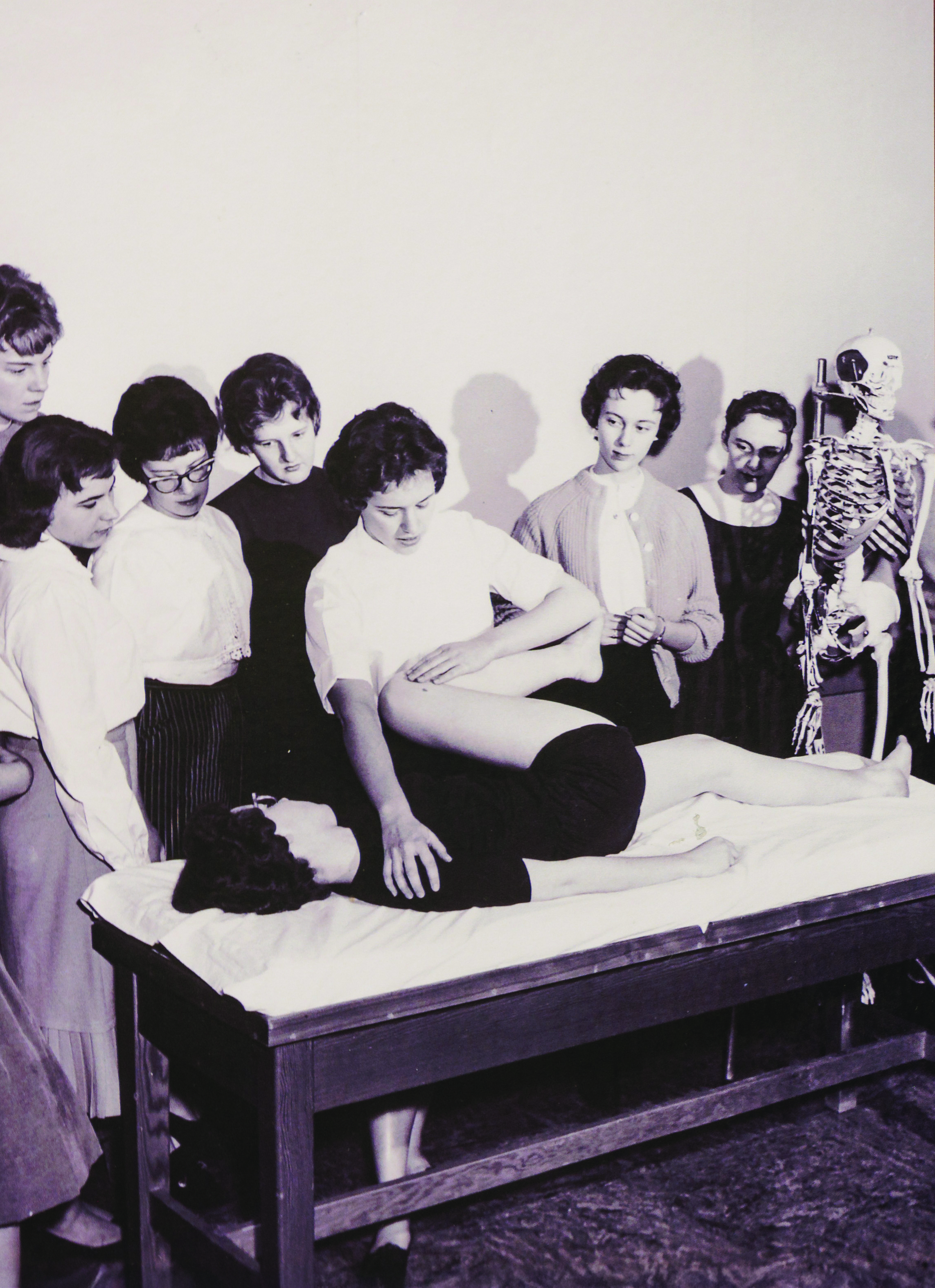 Elaine Hirst and her physiotherapy classmates watching an instructor demonstrate a clinical technique