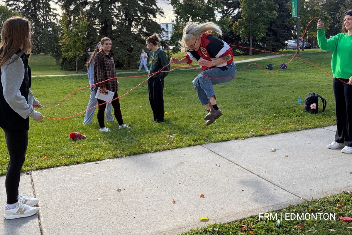 Students jumping rope in front of Corbett Hall