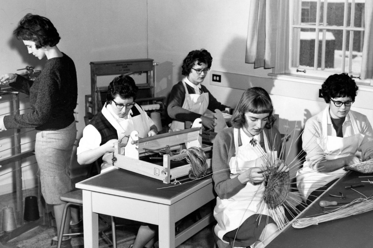 Occupational therapy students weaving baskets in a classroom, in black and white