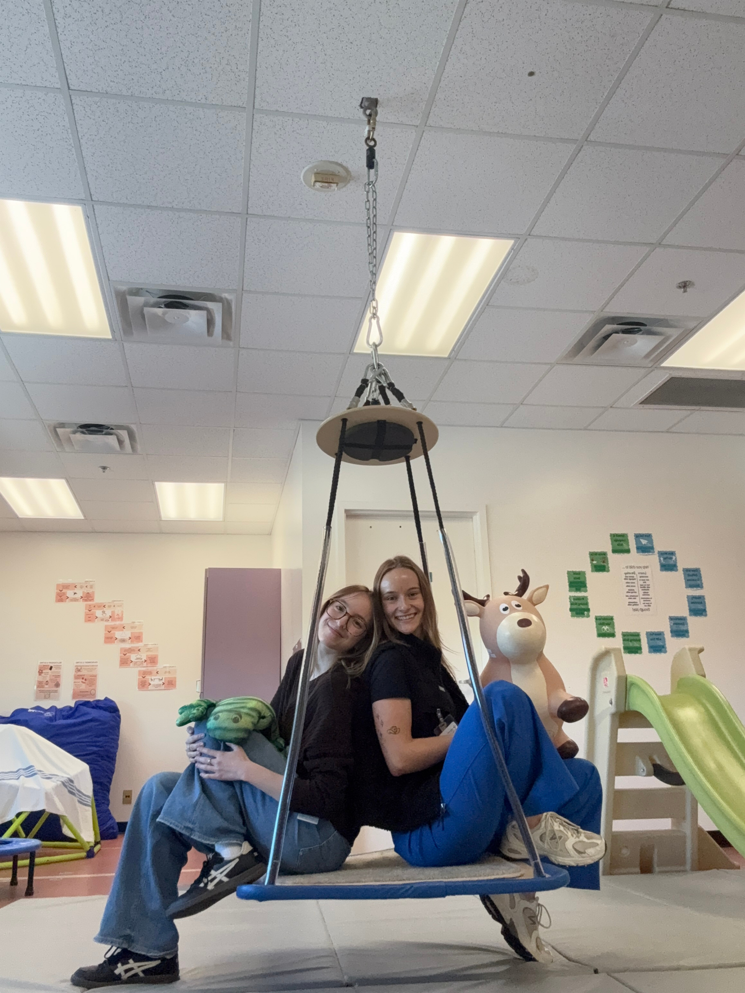Two people on a swing in a clinic placement