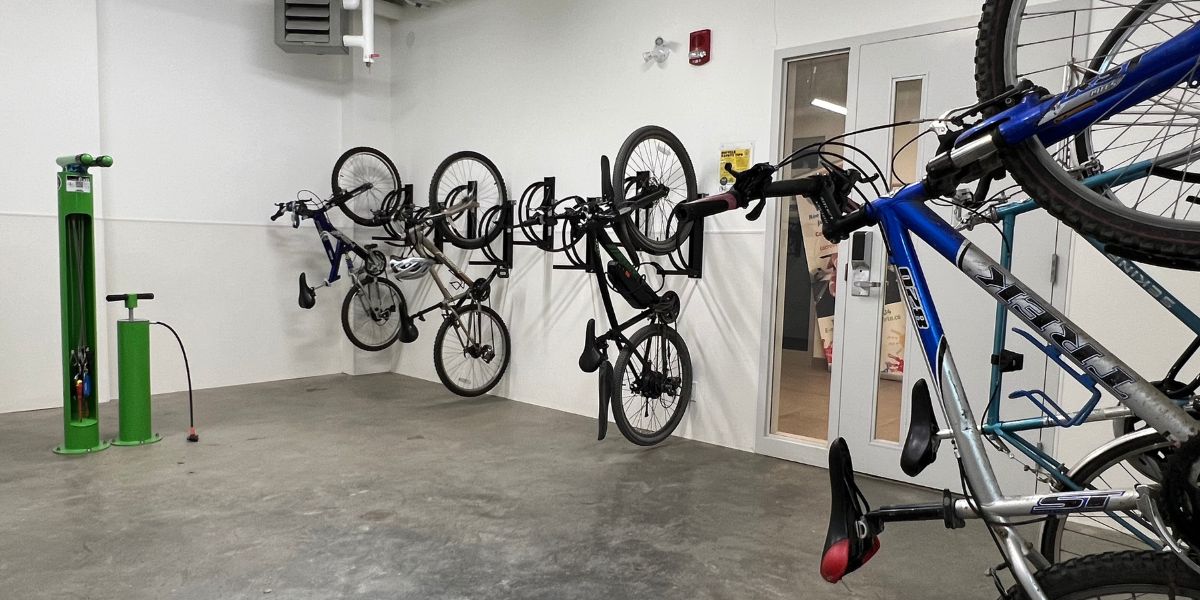 Bikes hanging from bike racks and a maintenance station