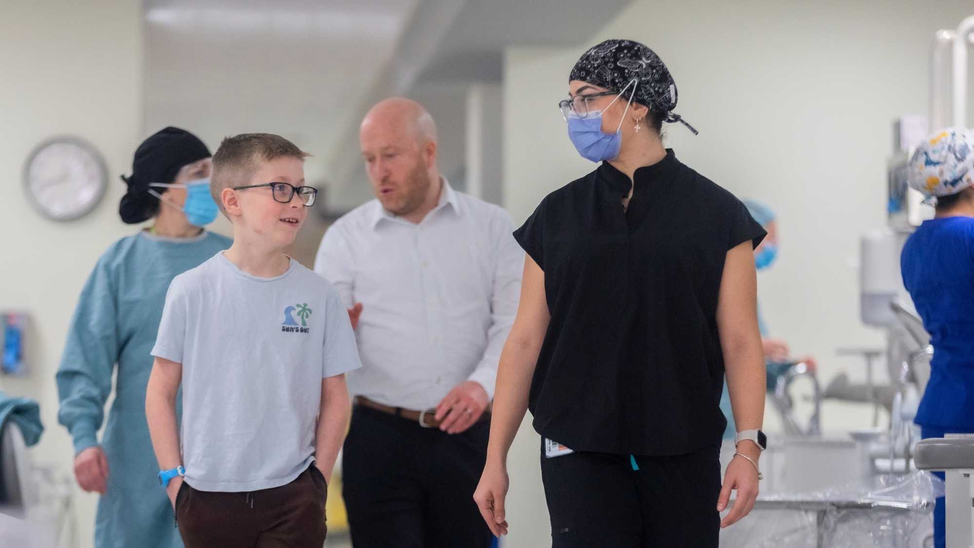 Student and patient walking through the clinic.